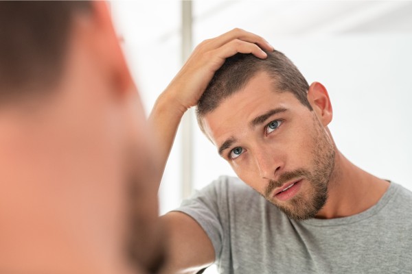 Use of genetics in the prediction of success in male pattern hair loss therapy and mechanistic studies
